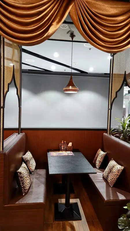 Private booth with gold curtains and cushions