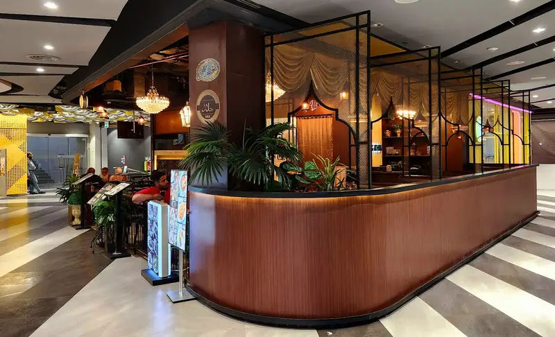 Ali's wood-panelled counter and dining room with chandeliers