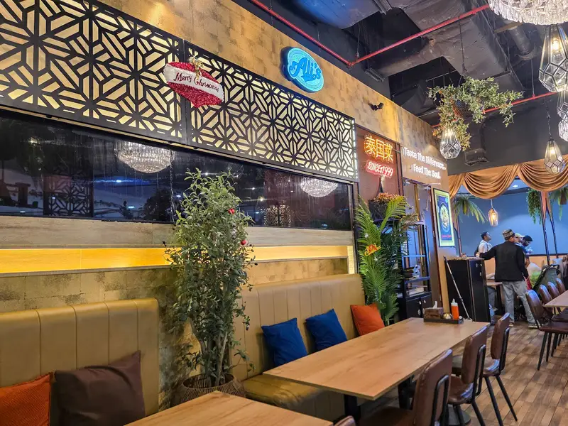 Dining room with carved lattice screens and blue Ali's sign