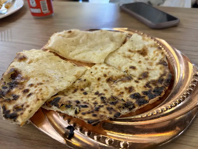 Fresh naan on a copper plate